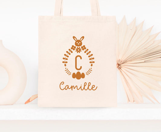 Mini tote bag Pâques personnalisé lapin et fleurs printanières, petit sac chasse aux œufs en jute naturel avec prénom - Collection Pâques Mahelia Design